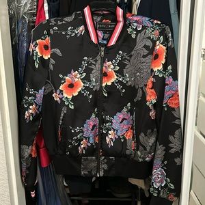 This jacket is 100% polyester.  Its from Polly & Esther. Size small for women.